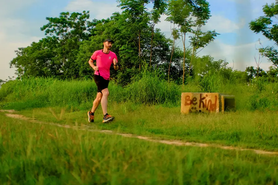 A picture of Phill running past a block of concrete with Be Kind graffiti